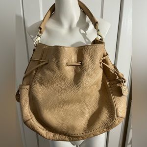 Cole haan Leather bag.  Pen marks inside. Small line on back of bag